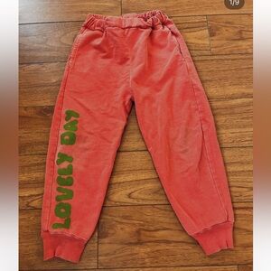 Fresh Dinosaurs Kids Red Joggers. Neutral gender. 100% organic cotton.